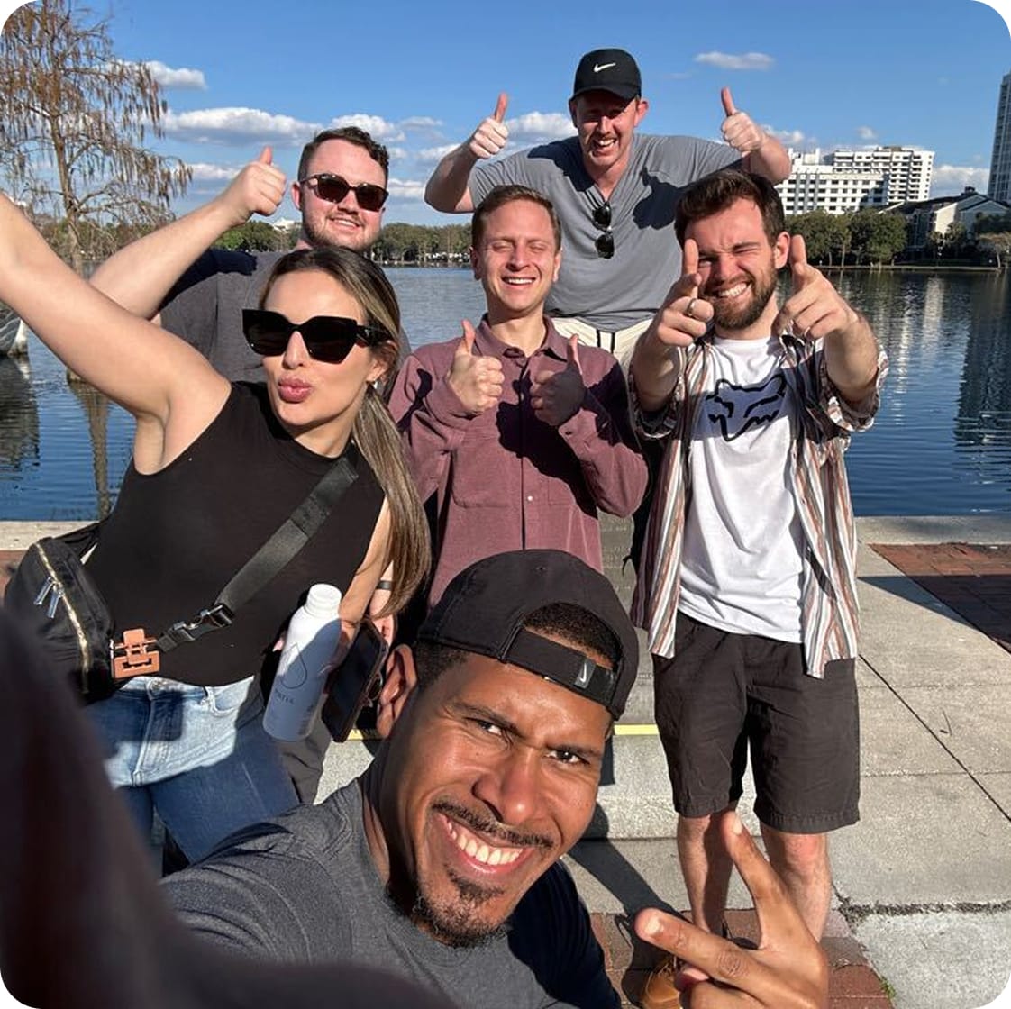 Group of LinearB employees giving thumbs up.
